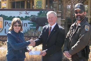 Skip Morgan presents a check to Dorris Morris representing Friends of Pocosin Lakes