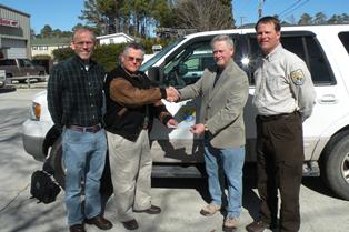 Skip Morgan presents a check to Coastal Wildlife Refuge Society President Stanley Oliver